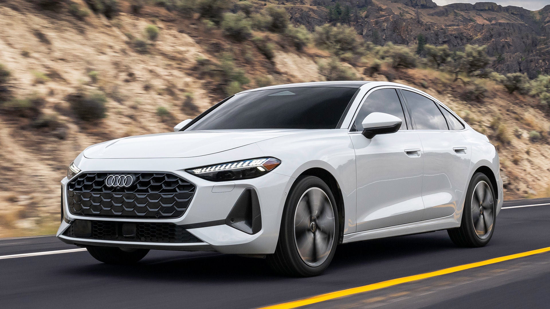 Drivers side profile view of an Audi A5 accelerating.